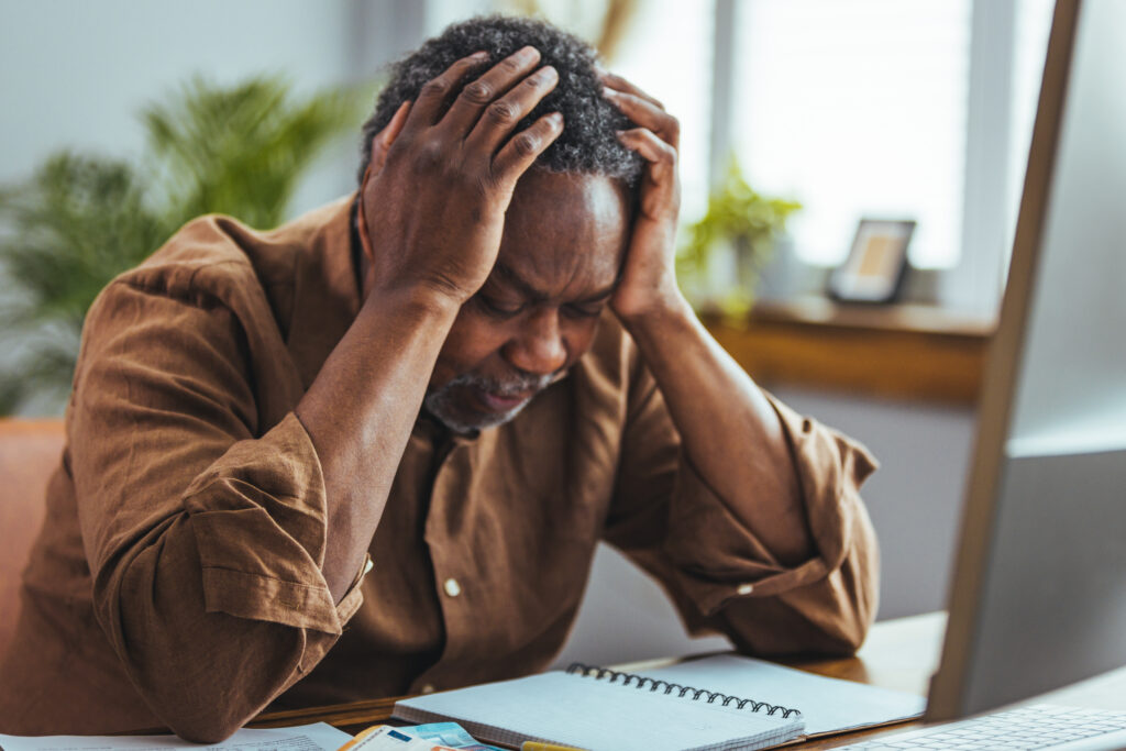 worried upset older man sit at table with laptop, counts expenses, manage budget, check bills for payment, thinks on financial problems, looks stressed due to lack of money, huge monthly fee concept